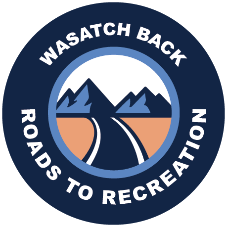 Wasatch Back Roads to Recreation circular logo with mountains and a winding road.